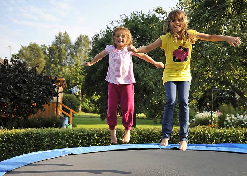 Children On Trampoline Back Yard