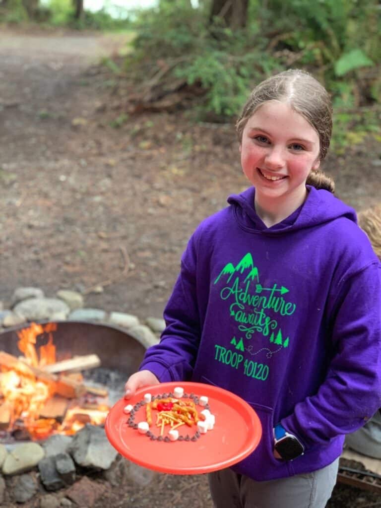 Girl Scout near a campfire